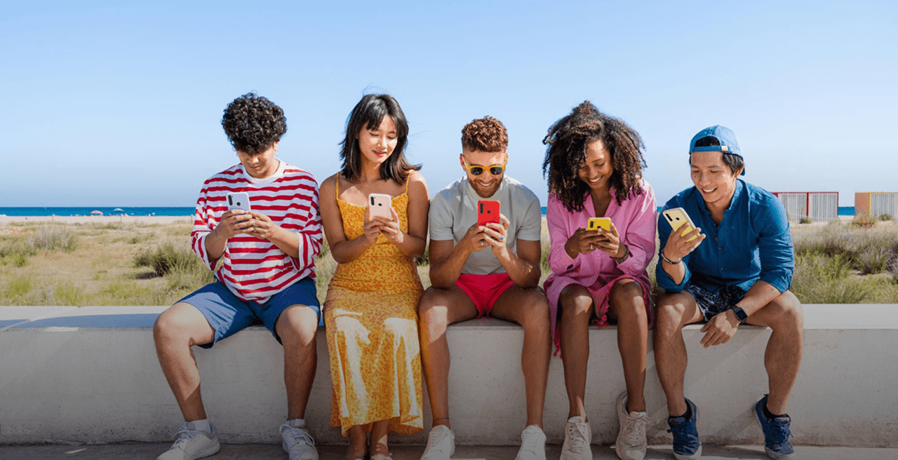Group of young travelers using mobile phones